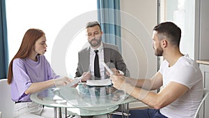 Young couple visiting lawyer, refuse sign decree paper and finalize divorce.