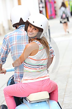 Young couple visiting town with motorcycle