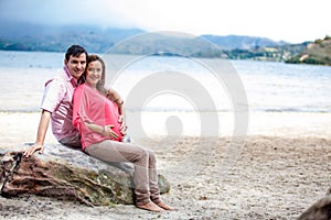 Young couple waiting for their baby at the beautiful white beach of Lake Tota located in the department of Boyaca at 3,015 meters