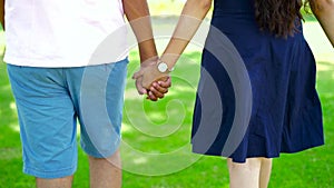 Young couple walk in park with holding hand