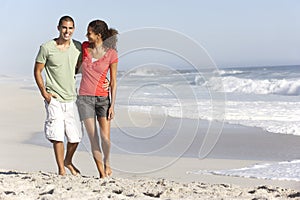 Young Couple Walking Along Beach