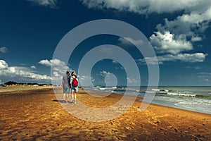 Young Couple Walking Along Beach Walking Together Concept Rear View