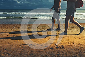 Young Couple Walking Along Beach Walking Together Concept Rear View