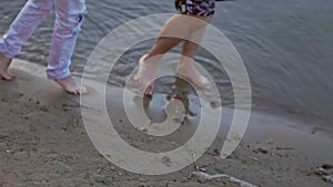 Young couple walking along the sandy coast