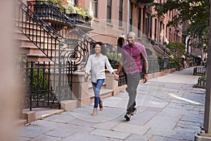 Young Couple Walking Along Urban Street In New York City