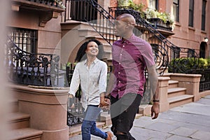 Young Couple Walking Along Urban Street In New York City