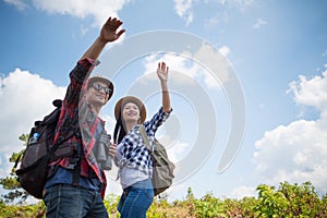 Young couple walking with backpacks in forest. Adventure hikes, Enjoy holidays