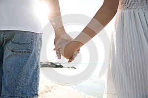 Young couple walking on beach. Honeymoon trip