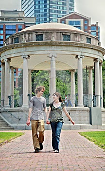 Young couple walking in city park