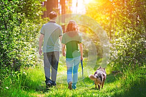 Young couple walking with dog