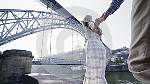 Young couple walking on embankment