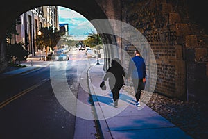 Young couple walking hand in hand through a tunnel