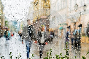 Young couple walking hand in hand without an umbrella, not noticing the rain. They happy together. Concept of modern