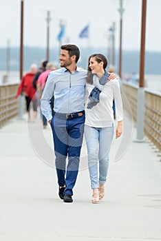 Young couple walking on pier photo