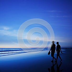 Young Couple Walking on Romantic Beach at Twilight