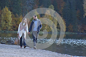 Young couple walking together on a beach and holding hands