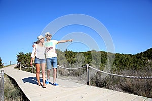 Young couple walking on a wooden pontoon