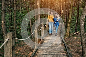 A young couple walks in the woods with a little boy