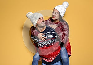 Young couple in warm sweaters and knitted hats