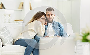 Young couple watching horror film, spending weekend at home