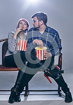 A Young couple watching movie. They are worried