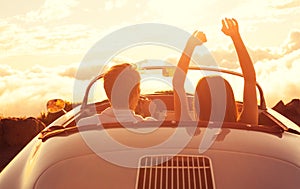 Young Couple Wathcing the Sunset in Vintage Sports Car