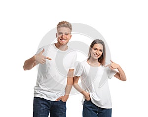 Young couple wearing blank t-shirts  on white. Mockup for design
