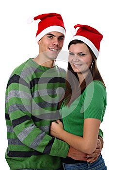 Young couple wearing Santa hats isolated on white