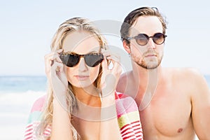 Young couple wearing sunglasses at beach