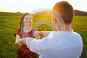 Young couple whirls in the field