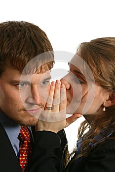Young Couple whispering at work