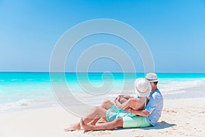 Young couple on white beach during summer vacation. Happy lovers enjoy their honeymoon