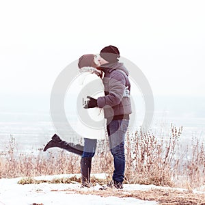 Young couple winter park, forest, kissing, love each other, happy family, idea style concept relationships, in clothes