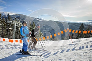 Young couple of women enjoying skiing at ski resort