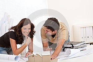 Young couple working at architect office