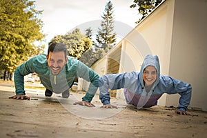 Young couple working pushbuttons on street. Healthy lifestyle.