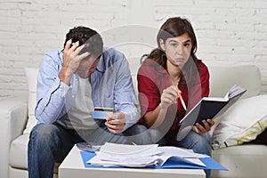 Young couple worried and desperate on money problems at home in stress accounting bank payments