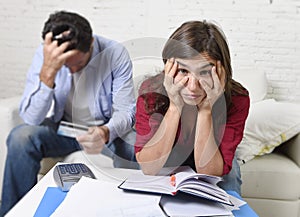 Young couple worried and desperate on money problems at home in stress accounting bank payments