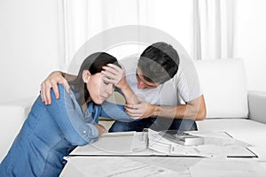 Young couple worried home in stress husband comforting wife in financial problems