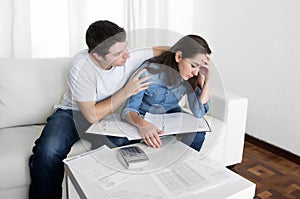 Young couple worried home in stress husband comforting wife in financial problems