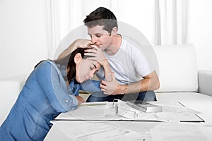 Young couple worried home in stress husband comforting wife in financial problems