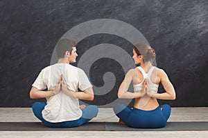 Young couple in yoga class, back stretching