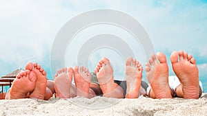 Young couples feet at the beach