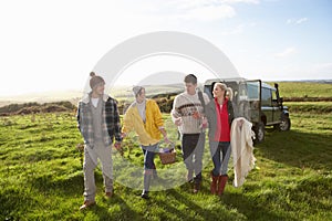 Young couples going for picnic in countryside