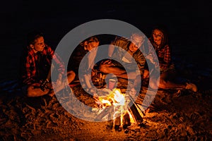 Young couples have picnic with bonfire on the beach