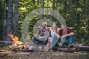 Young couples having picnic in woods. Romantic picnic forest. Young people having a camping. Spring or autumn camping