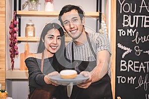 Young couples making bakery donuts and bread at bakery shop as b