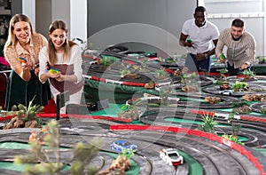 Young couples play a game slot car racing track