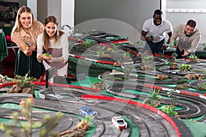 Young couples play a game slot car racing track