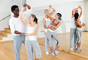 Young couples practicing active dance in pair